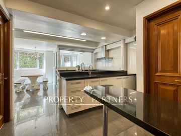 Departamento con vista panorámica a Santiago, jardín y piscina privada
