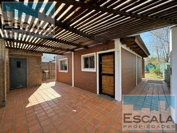 CASA DE DOS DORM  CON COCHERA CUBIERTA, PATIO Y JARDIN EN ROLDAN
