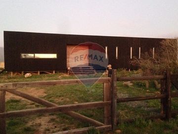 Parcela con casa vista al mar en Los Molles