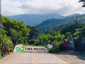 Land for sale in Chiang Mai Hangdong-Samoeng Road Near Flora Creek Hotel, a wide stream running through the land.