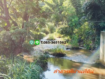 Land for sale in Chiang Mai Hangdong-Samoeng Road Near Flora Creek Hotel, a wide stream running through the land.