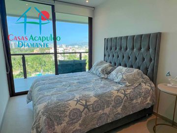 Departamento en renta vacacional, terraza con vista a las albercas y áreas comunes