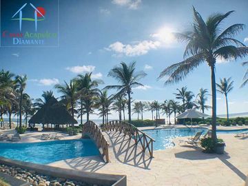 Departamento en renta vacacional, terraza con vista a las albercas y áreas comunes