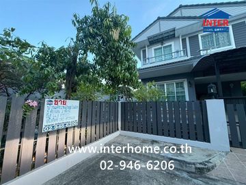Two-story detached house, 64.5 sq.w., Chonlada Suvarnabhumi Village. Krungsri Ayutthaya Bank is located at the entrance of the soi (lane), Soi Ladkrab