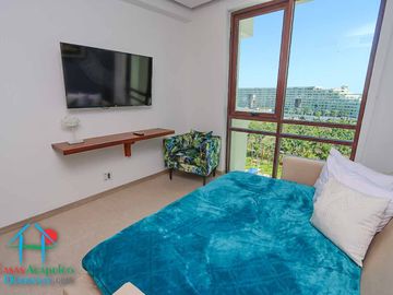 Departamento en renta vacacional. Terraza con vista a las albercas, jardines y parcial al mar