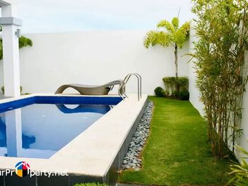 white house with swimming pool for sale in amara subdivision liloan cebu